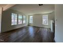 Spacious living room featuring hardwood floors, multiple windows, and neutral paint colors that brighten the space at 89 Willow Cameron Way, Angier, NC 27501
