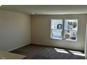 Comfortable living room featuring plush carpeting and large windows, creating a welcoming atmosphere at 921 Emmer St, Rolesville, NC 27571