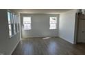 Bright living room featuring hardwood floors and multiple windows, providing lots of natural light at 921 Emmer St, Rolesville, NC 27571