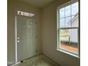 Home entryway featuring a white door with glass detailing and a bright window showcasing the outdoors at 98 Willow Cameron Way, Angier, NC 27501
