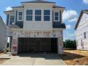 Two-story home under construction with a prominent two-car garage and light blue siding at 98 Willow Cameron Way, Angier, NC 27501