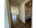 Bright hallway featuring beautiful wood flooring, leading into an open-concept living space at 98 Willow Cameron Way, Angier, NC 27501
