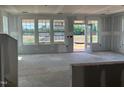 Spacious living room featuring large windows and a glass patio door, under construction at 98 Willow Cameron Way, Angier, NC 27501