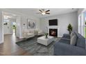 Cozy living room featuring a fireplace, contemporary furnishings, and ample natural light at 53 Merele Dr, Wendell, NC 27591