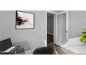 A stylish office features a modern glass desk, contemporary artwork, and a frosted glass door for added privacy at 53 Merele Dr, Wendell, NC 27591