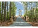 Long gravel driveway leads to a private estate surrounded by a lush green forest at 1018 Terrell Woods Ln, Chapel Hill, NC 27516