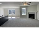 Spacious living room features a fireplace, ceiling fan, and lots of natural light at 111 Magnolia Run Way, Benson, NC 27504