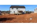 Rear exterior of new construction home with a small covered porch and unfinished lot at 1414 Reading Ct # 91Kl, Burlington, NC 27217