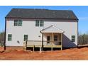 Rear exterior of new construction home with a small covered porch and unfinished lot at 1414 Reading Ct # 91Kl, Burlington, NC 27217