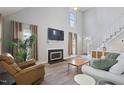Bright living room with a fireplace, soaring ceilings, and hardwood floors at 1721 Kingston Heath Way, Raleigh, NC 27604