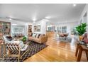 Bright open-concept living room with hardwood floors, stylish furniture, and lots of natural light at 1824 S Lakeshore Dr, Chapel Hill, NC 27514