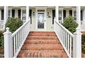 Inviting front entrance with brick steps, white railings, and decorative glass door at 19 Juneberry Pl, Clayton, NC 27527