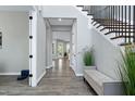 Spacious hallway featuring hardwood floors, neutral walls, and ample natural light at 213 W Weatherford Dr, Angier, NC 27501