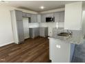 Modern kitchen featuring gray cabinets, granite countertops and stainless steel appliances at 223 Magnolia Run Way, Benson, NC 27504