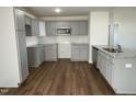 Modern kitchen featuring gray cabinets, granite countertops and stainless steel appliances at 223 Magnolia Run Way, Benson, NC 27504