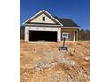 New home construction showing the unfinished exterior with tan siding and open garage at 235 Meadowbark Bnd # 26, Garner, NC 27529