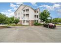 Condo building exterior featuring private balconies and ample parking at 3009 Winston Dr # 90, Burlington, NC 27215