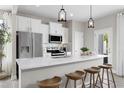 Bright kitchen features modern appliances, sleek countertops, and a breakfast bar with seating at 341 Church St # 67, Wendell, NC 27591