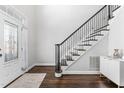Bright foyer with an elegant staircase and gleaming wood floors creates a welcoming entrance to the home at 4270 Aviemore Run, Burlington, NC 27215