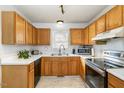Functional kitchen featuring stainless steel appliances, light countertops and wood cabinetry at 435 Fowlkes St, Wendell, NC 27591