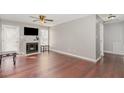 Open-concept living room featuring a fireplace, hardwood floors, and natural light at 435 Fowlkes St, Wendell, NC 27591