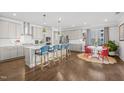 Spacious open-concept kitchen with modern appliances, white countertops, and hardwood floors at 516 Ivy Arbor Way, Holly Springs, NC 27540