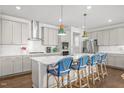 Bright kitchen with stainless steel appliances, white countertops, and a large island with seating at 516 Ivy Arbor Way, Holly Springs, NC 27540