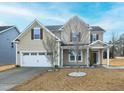 Charming home featuring a two-car garage, a well-manicured lawn, and a welcoming front porch at 800 Tree Green Ln, Wake Forest, NC 27587