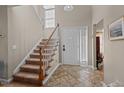 Inviting foyer with a staircase, tile flooring, a coat closet, and a front door with sidelights at 886 Drogheda Pl, Wake Forest, NC 27587