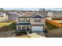 Aerial view of a two-story home with a two-car garage and a well-manicured front lawn at 1020 Broadlands Way, Graham, NC 27253