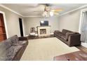 Inviting living room with fireplace, ceiling fan, and comfortable seating at 1043 Cavel Chub Lake Rd, Roxboro, NC 27574