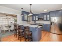Modern kitchen featuring blue cabinets, stainless steel appliances, and a stylish breakfast bar at 1107 S 2Nd St, Smithfield, NC 27577