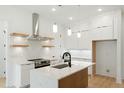 Bright, modern kitchen with white cabinets, stainless steel appliances, and a central island at 112 Fort Dr, Louisburg, NC 27549