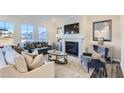 Bright living room featuring a cozy fireplace, comfortable seating, and large windows at 124 N Finley Landing Parkway # 4, Smithfield, NC 27577
