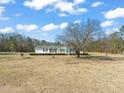 View of a well-kept single story home surrounded by trees at 1304 Nc 96 Hwy S, Zebulon, NC 27597
