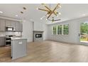 Spacious living room features a modern fireplace, hardwood floors, and ample natural light from large windows at 136 E End Ave # 4, Durham, NC 27703