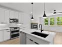 Kitchen featuring white cabinets, stainless appliances, and modern countertops at 140 E End Ave # 2, Durham, NC 27703