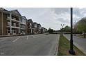 Exterior street view of a brick apartment building with green space at 1400 Gathering Park Cir # 202, Cary, NC 27519