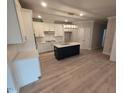 Bright kitchen features a center island, white cabinets and stainless steel appliances at 1400 Gathering Park Cir # 202, Cary, NC 27519