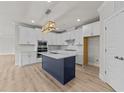 Spacious kitchen boasting a navy island, modern appliances, and ample cabinet space at 1400 Gathering Park Cir # 202, Cary, NC 27519