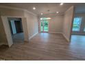Open-concept living room with hardwood floors, recessed lighting, and patio access at 1400 Gathering Park Cir # 202, Cary, NC 27519