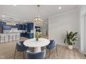 Open dining area featuring modern table set, views into kitchen, and plenty of natural light at 1400 Gathering Park Cir # 204, Cary, NC 27519