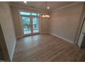 Bright living room with hardwood floors, light walls, and view through glass patio doors at 1400 Gathering Park Cir # 204, Cary, NC 27519