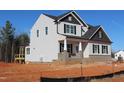 New construction two-story home with light siding, a brick foundation, black trim, and a screened-in back porch at 1415 Reading Ct # 77Kl, Burlington, NC 27217