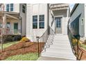 Inviting entrance with white brick stairs, black railings, and a light-gray front door at 1662 Piney Fls Dr, Wendell, NC 27591