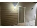 Front door entrance with a covered porch area, featuring a light fixture and unit number at 1828 Parkside Village Dr, Clayton, NC 27520