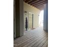 Entrance to the home featuring a covered porch, potted plant, and wooden decking at 1828 Parkside Village Dr, Clayton, NC 27520