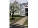 Attractive exterior of the home featuring well-maintained landscaping and gray facade with white trim at 1828 Parkside Village Dr, Clayton, NC 27520