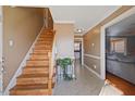 Inviting foyer with wood staircase and neutral decor at 209 James St, Apex, NC 27502