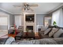 Bright living room featuring a fireplace, large windows and hardwood floors at 209 James St, Apex, NC 27502